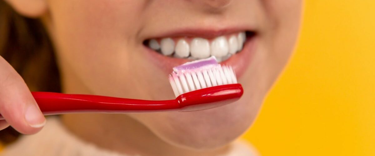 girl holding toothbrush