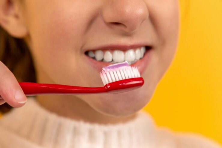 girl holding toothbrush